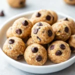 A bowl of fruit-sweetened no-bake cookie dough bites made with dates and oats