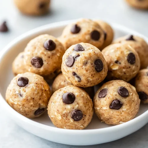 A bowl of fruit-sweetened no-bake cookie dough bites made with dates and oats