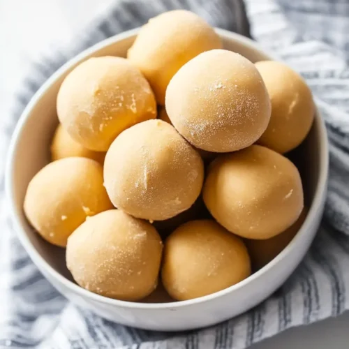 No-bake peanut butter balls without chocolate on a striped napkin – easy 3-ingredient snack.