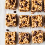 No-bake peanut butter oatmeal bars with chocolate chips on parchment paper