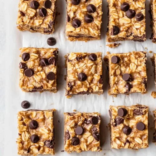 No-bake peanut butter oatmeal bars with chocolate chips on parchment paper